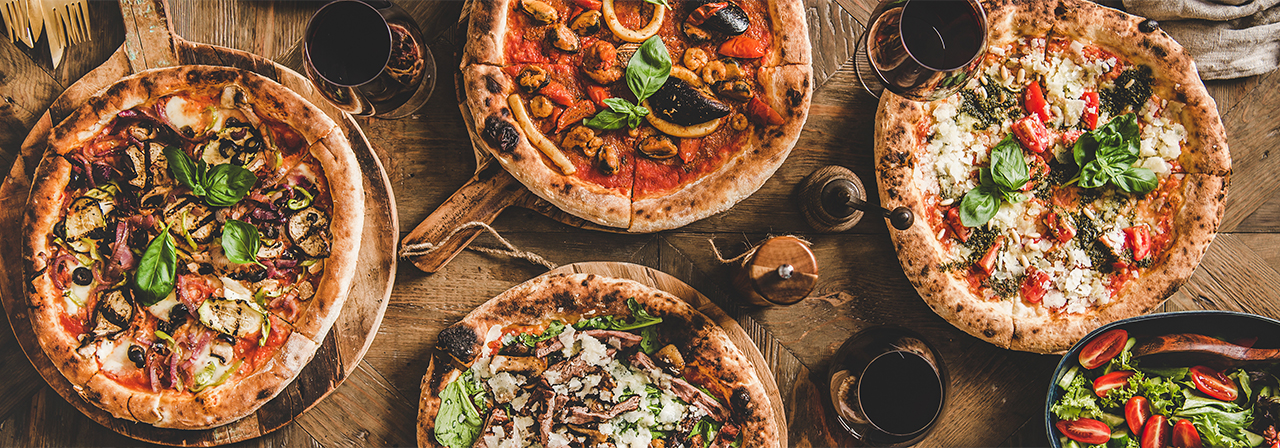 Pizza over rustic wooden table composition