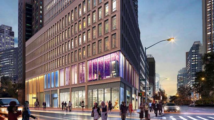 Street level view of property with people crossing intersection and retail space visible in background.