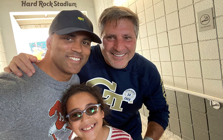 Chris Drew and daughter, Brooke, supporting colleague, Ed Coco, as they watch Ed’s son play football in Miami.