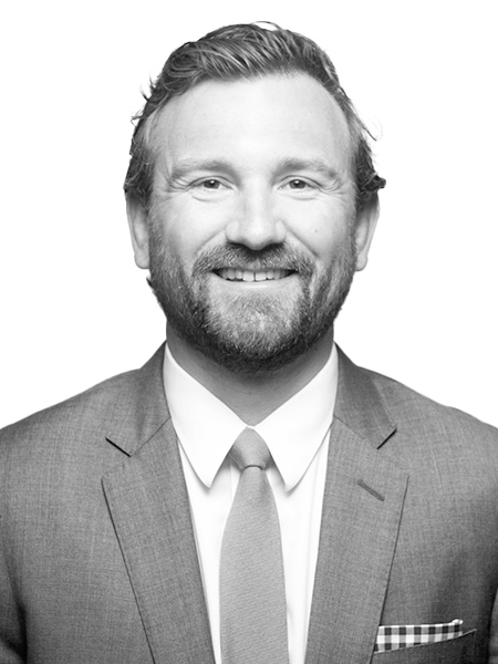 Headshot of a man with brown hair and a beard.