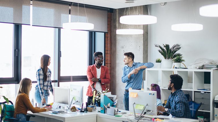 Team having conversation on team building activity in office workplace