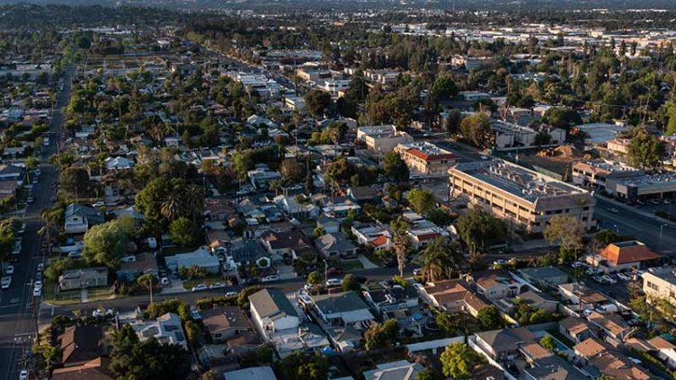 Aerial view showcasing a residential neighborhood in Los Angeles, featuring houses, streets, and greenery.