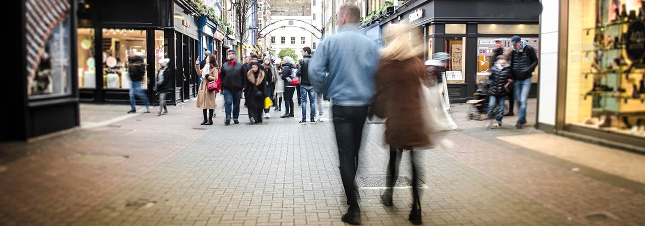 A crowd of pedestrians navigating a busy city street, highlighting the dynamic atmosphere of urban exploration.