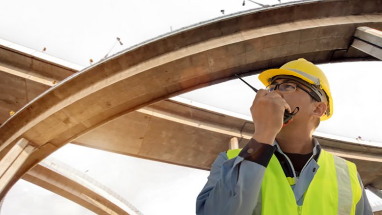 A man talking in walkie talkie at construction site