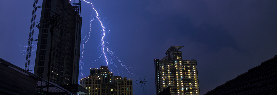 night view of a real estate building and thunder lightning