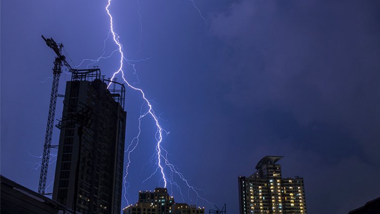 night view of a real estate building and thunder lightning