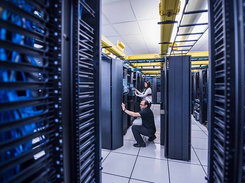 Data center workers providing routine server maintenance