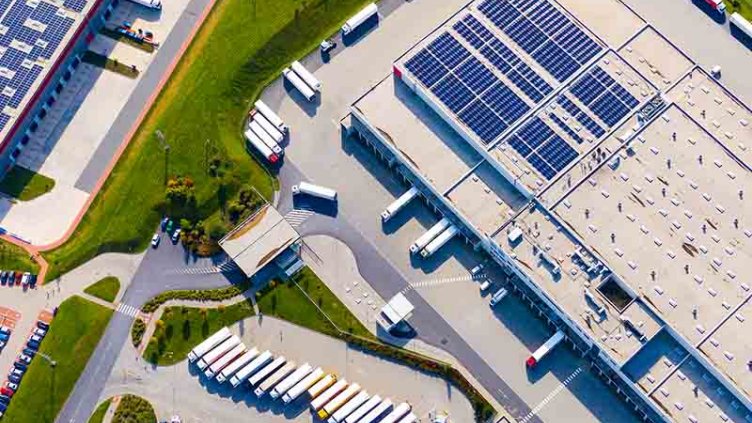 Industry with low carbon footprint. Industrial warehouses with solar panels on the roof.