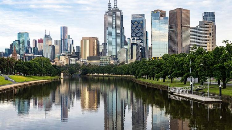 City buildings reflected in the river