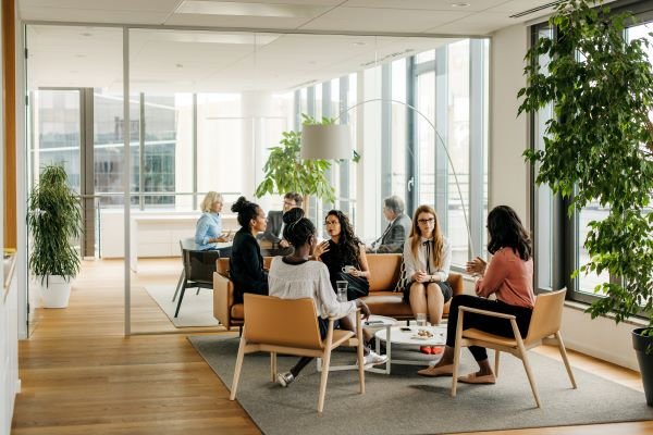 diverse people in office space working and collaborating 