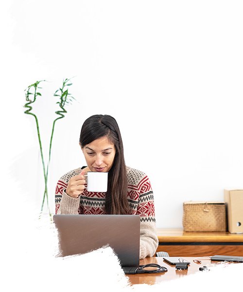 woman having coffee working on laptop