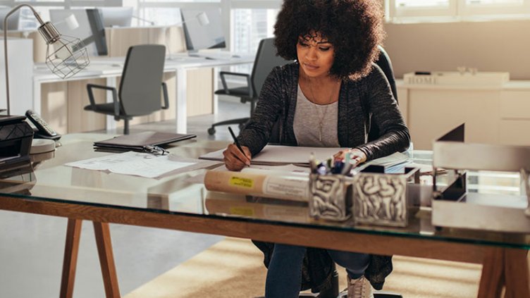 Woman working on new real estate building plans in the office